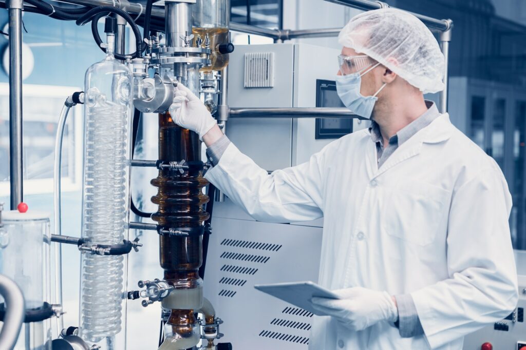 medicine factory scientist worker. Hemp oil extraction Thin Film Distillation Laboratory Process.